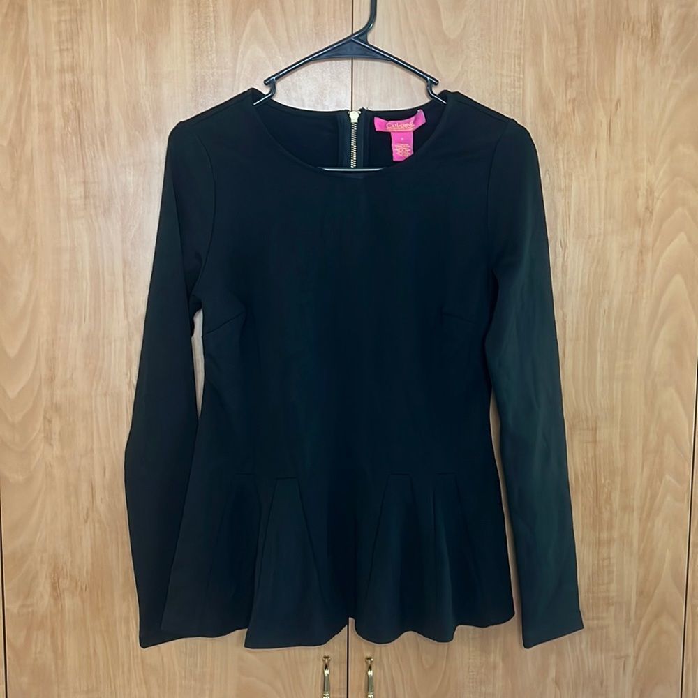 Catherine Malandrino black long sleeve shirt. Flares at waist. Zips in back